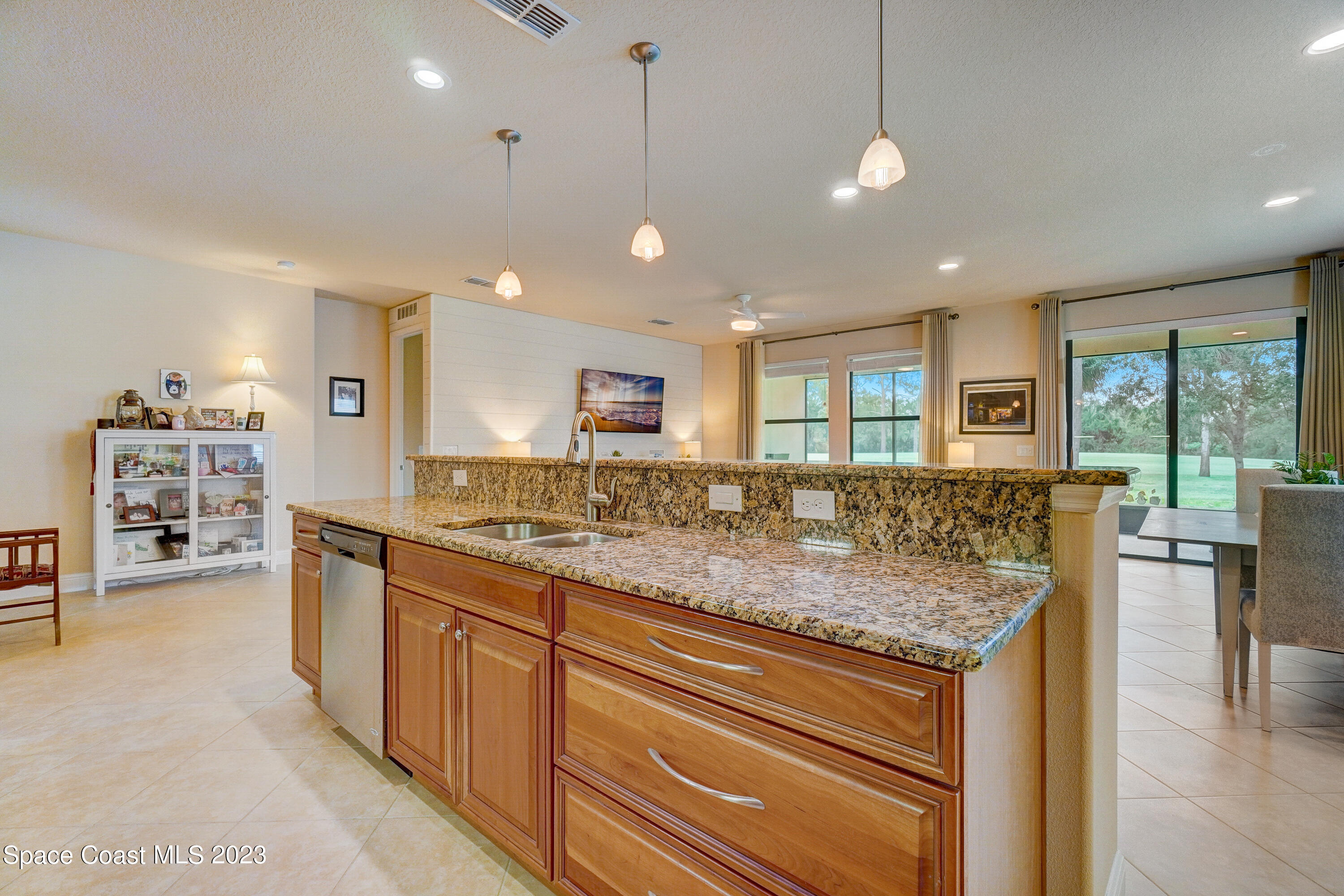 1568 Outrigger Circle Rockledge, FL 32955 - Photo 15 of 44 a kitchen with center island a sink appliances and a large window