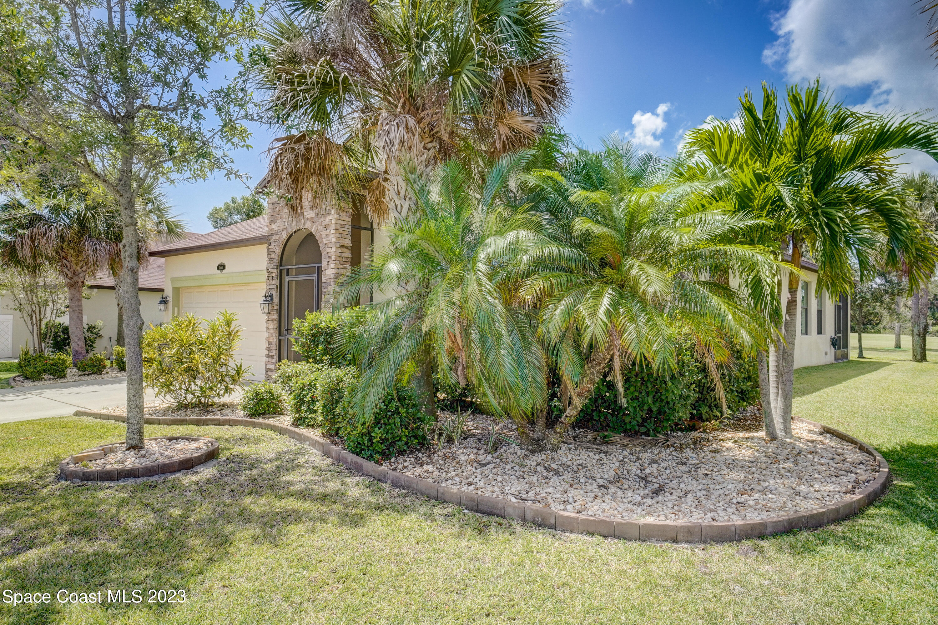 1568 Outrigger Circle Rockledge, FL 32955 - Photo 2 of 44 a view of a garden with a house