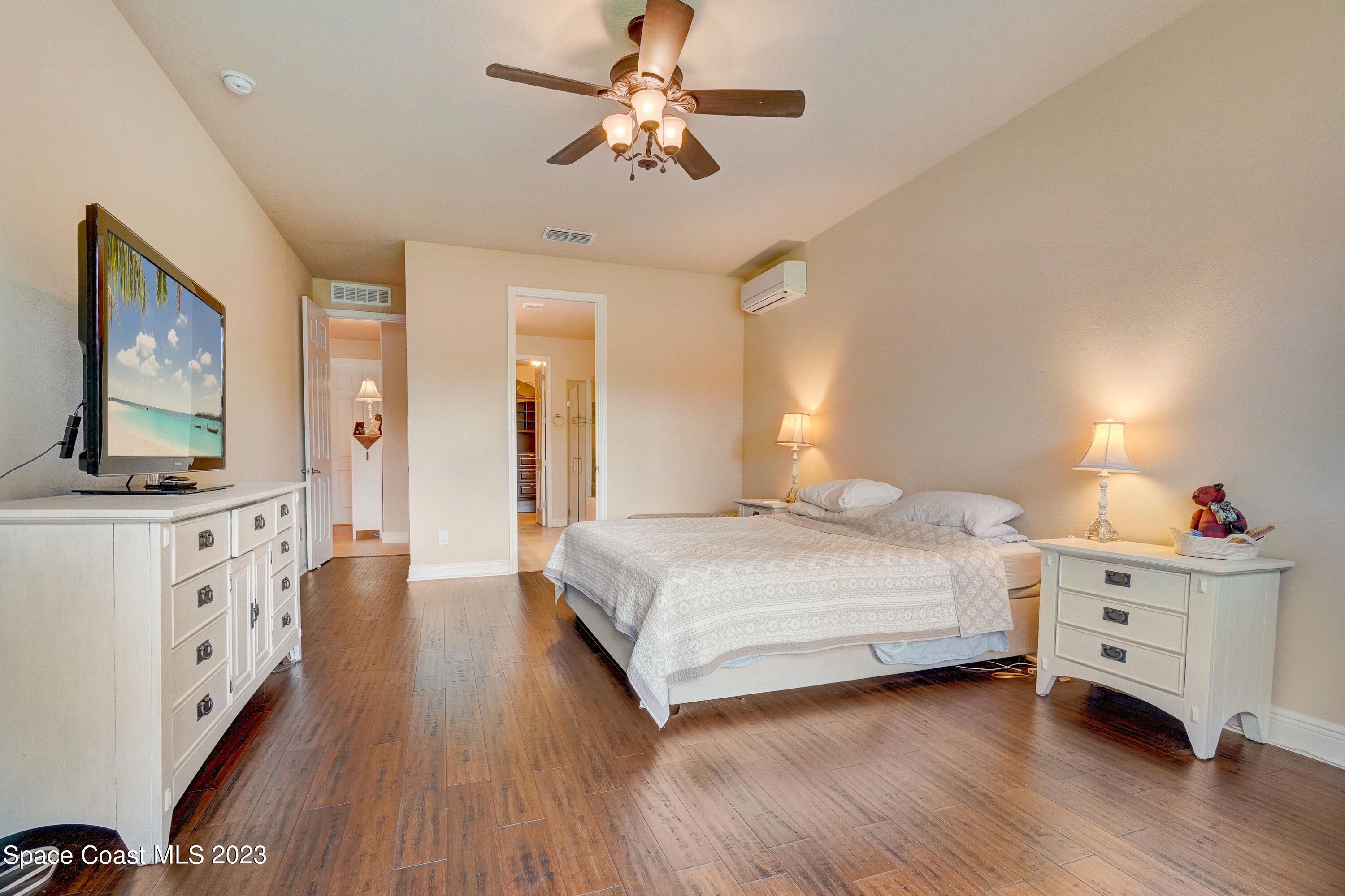 1568 Outrigger Circle Rockledge, FL 32955 - Photo 24 of 44 a bedroom with a bed and a flat screen tv