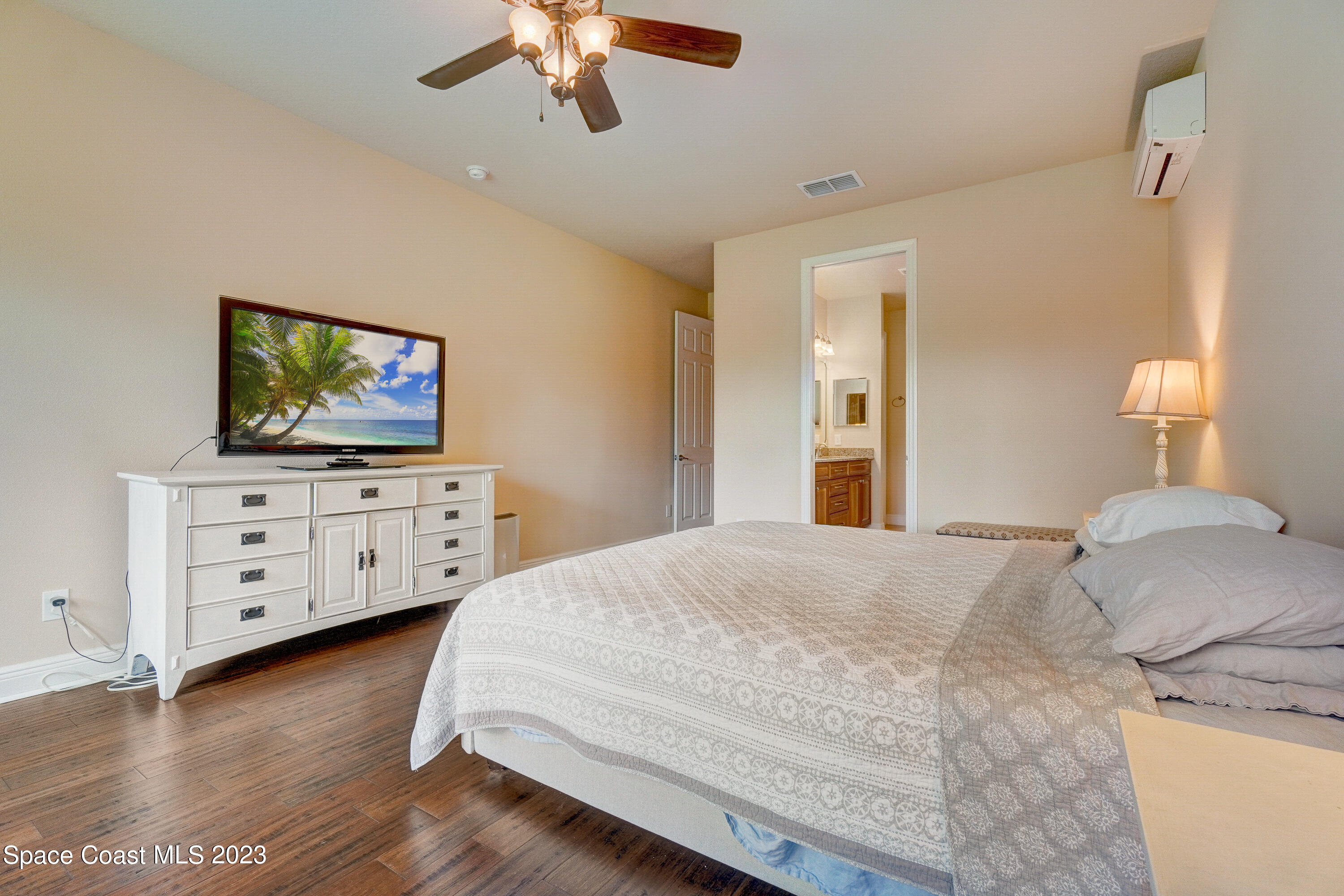 1568 Outrigger Circle Rockledge, FL 32955 - Photo 25 of 44 a bedroom with a bed and a flat tv screen on dresser