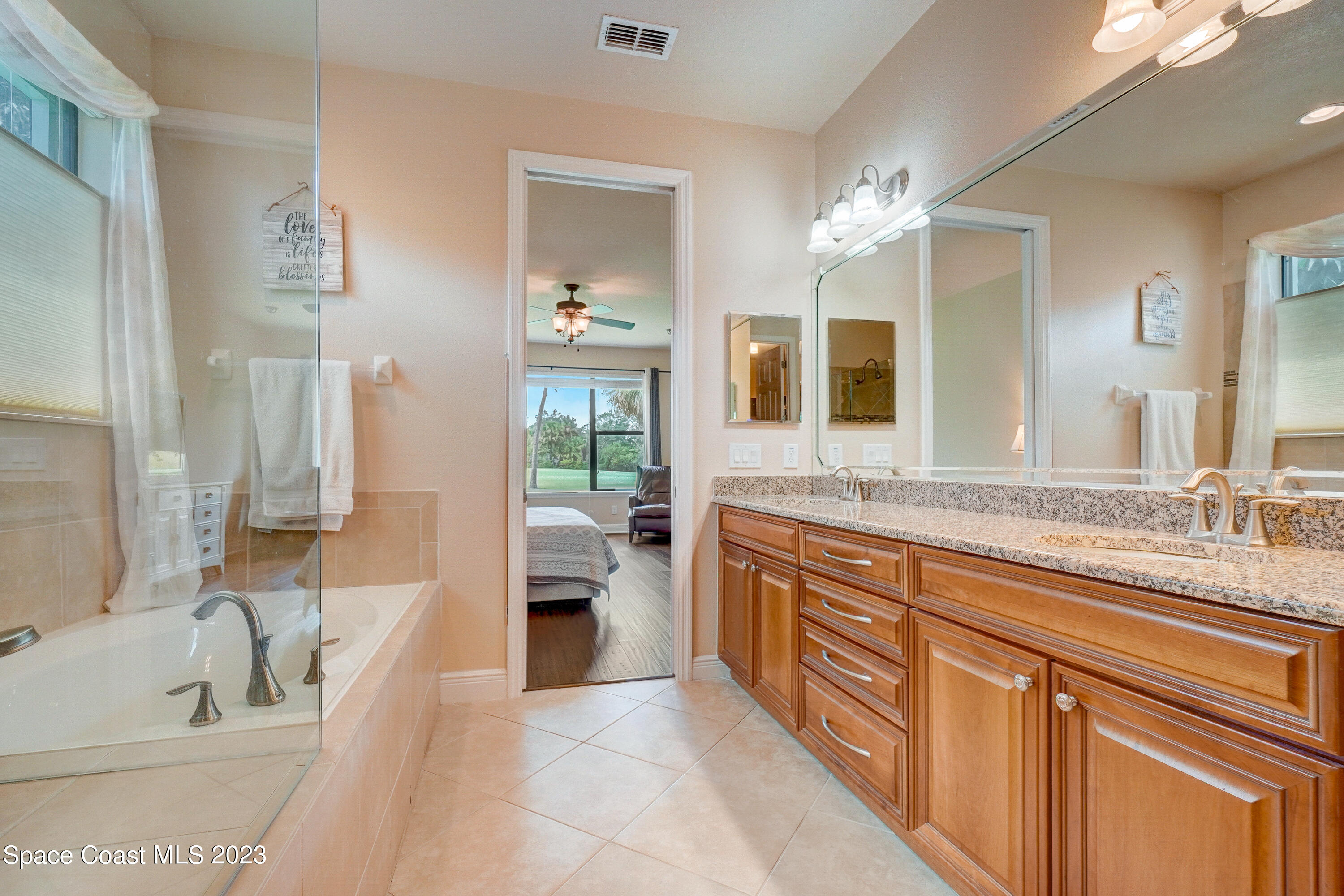 1568 Outrigger Circle Rockledge, FL 32955 - Photo 27 of 44 a spacious bathroom with a granite countertop sink mirror and bathtub