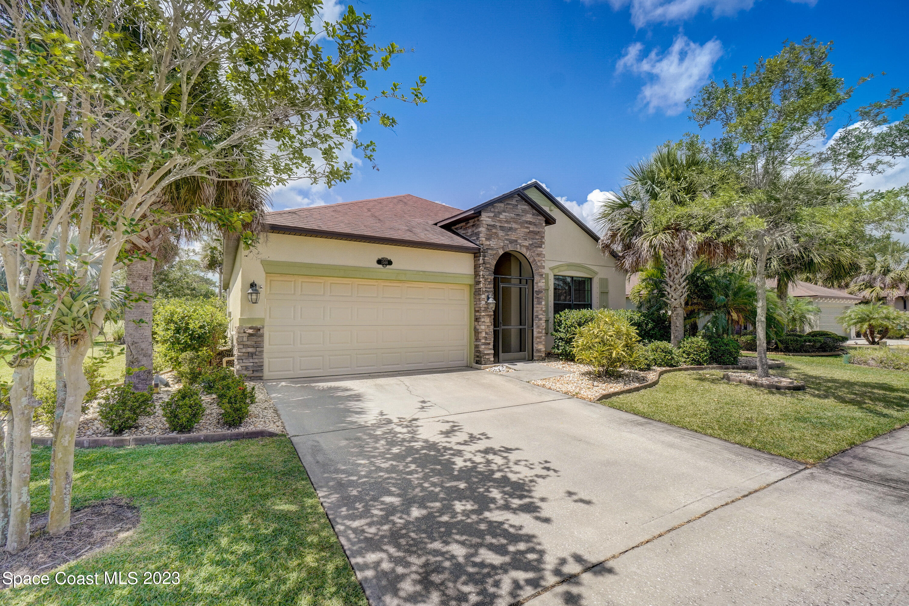 1568 Outrigger Circle Rockledge, FL 32955 - Photo 3 of 44 a front view of a house with a yard