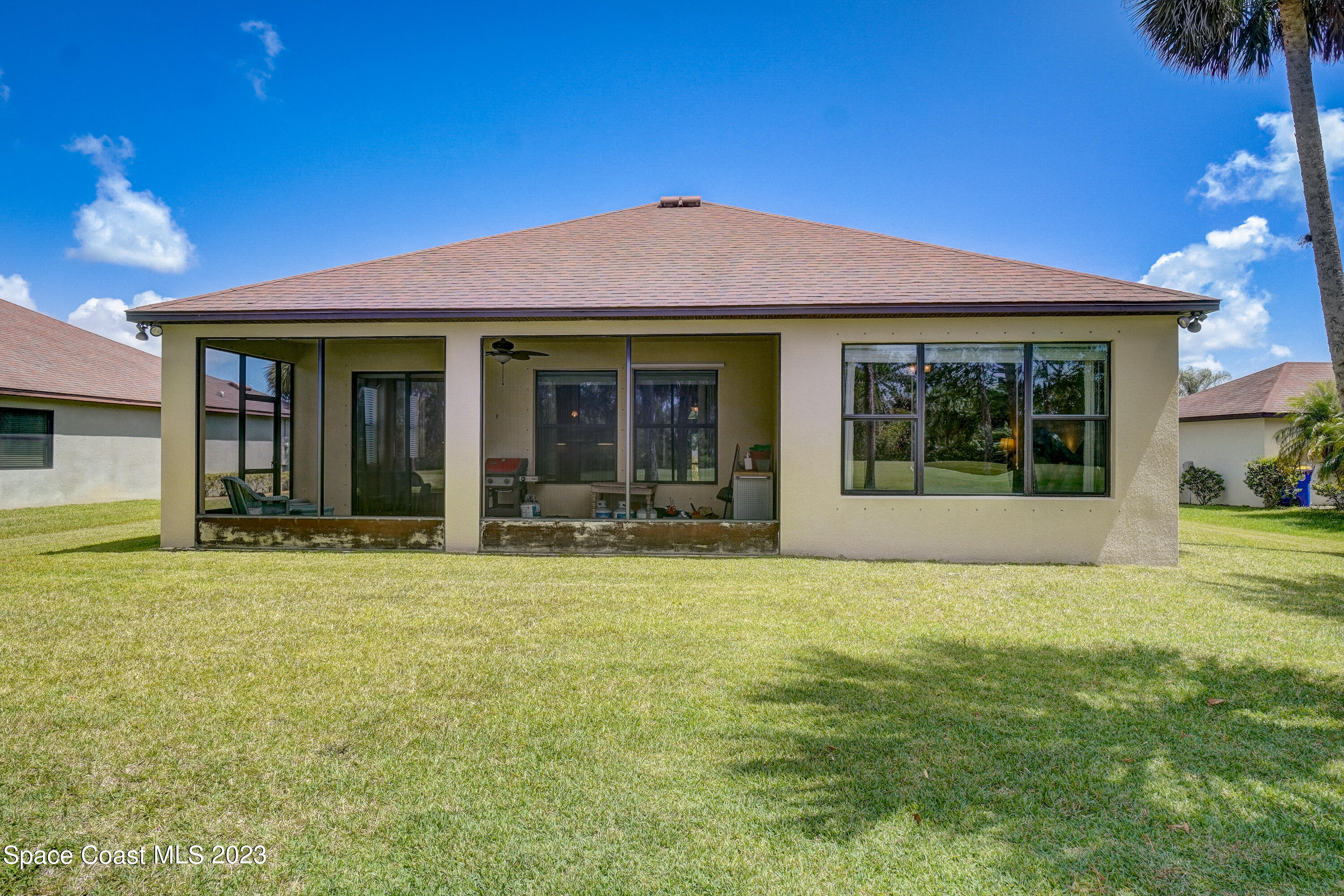 1568 Outrigger Circle Rockledge, FL 32955 - Photo 32 of 44 a view of a white house with a large pool and a yard