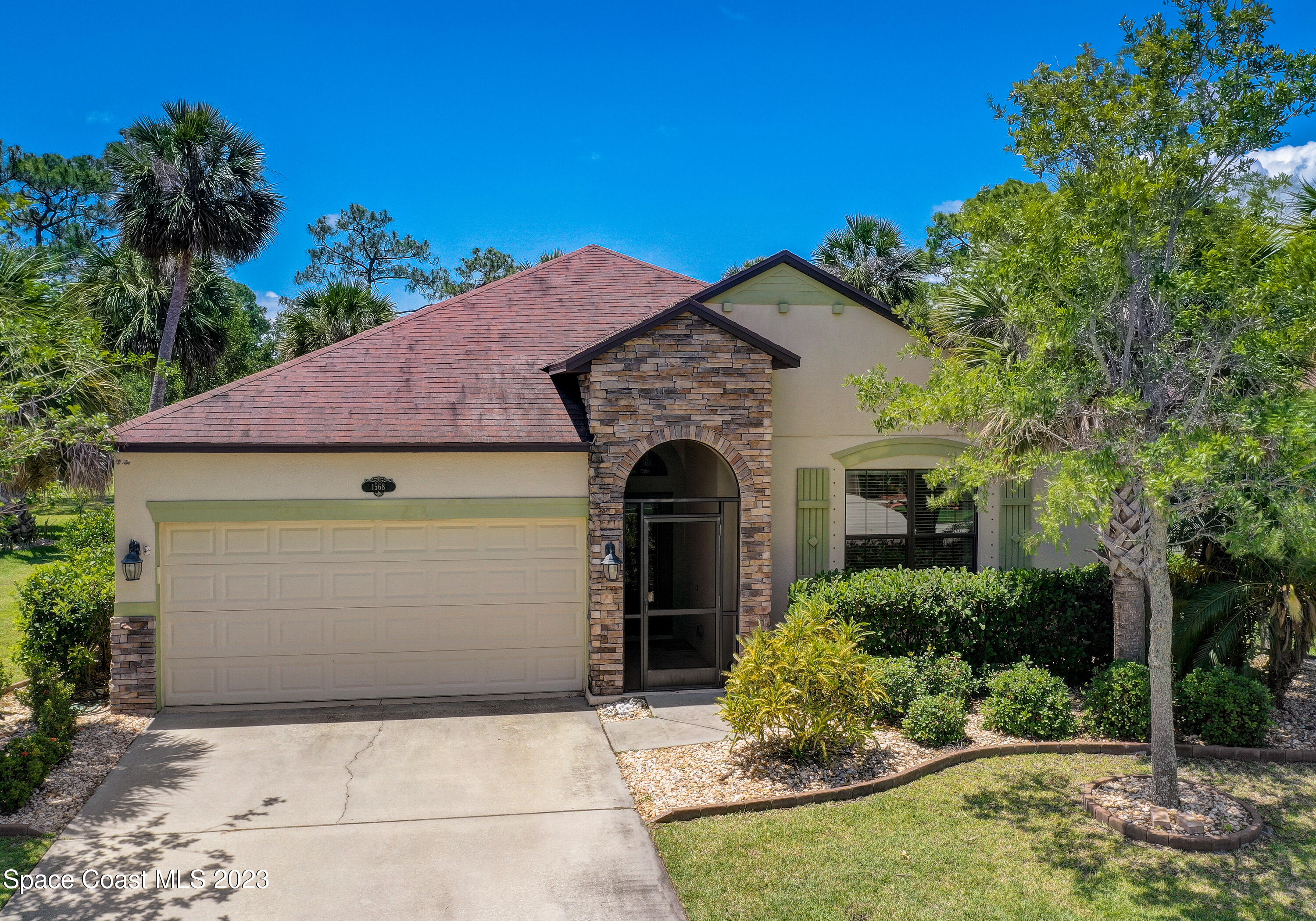 1568 Outrigger Circle Rockledge, FL 32955 - Photo 36 of 44 a front view of a house with garden