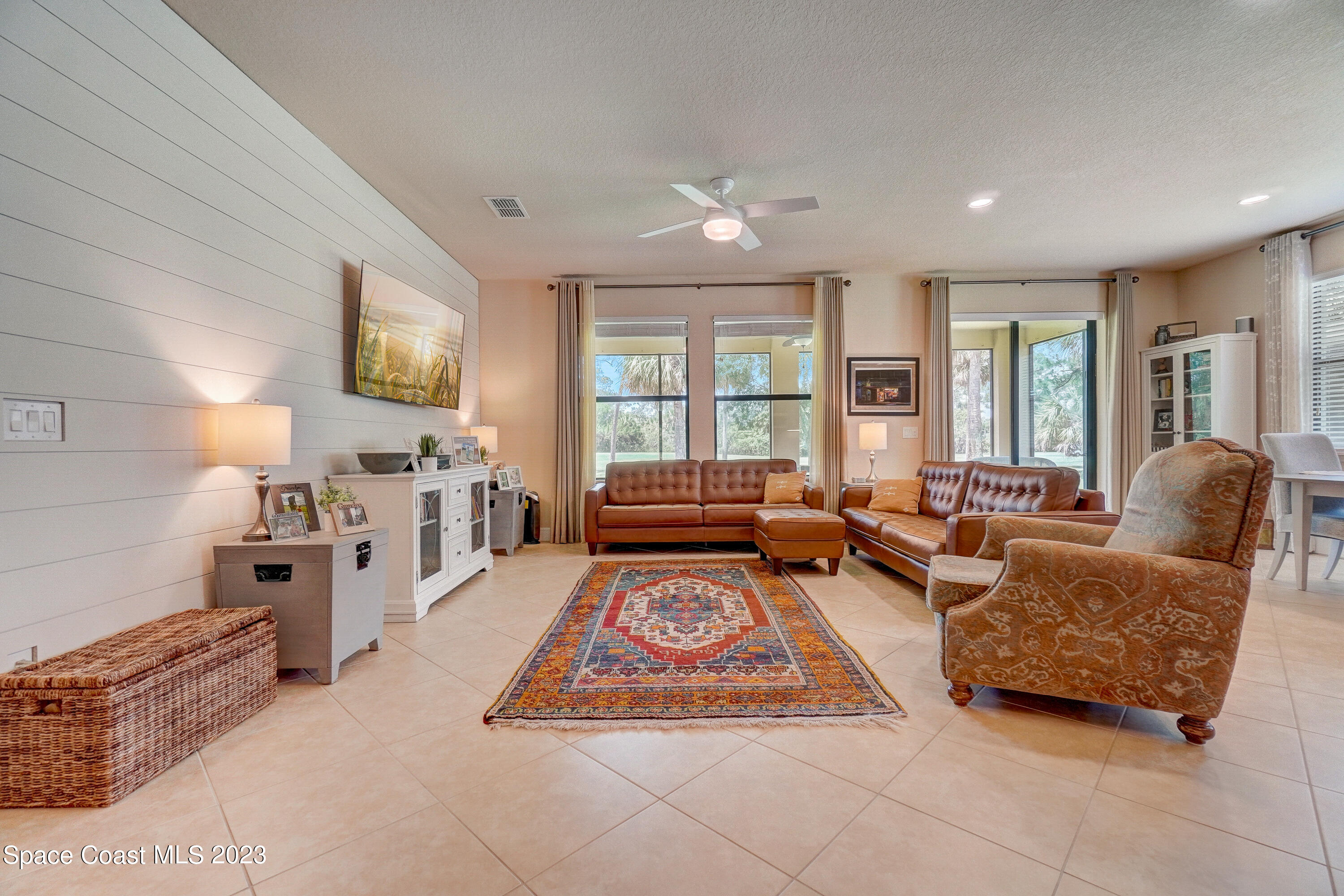 1568 Outrigger Circle Rockledge, FL 32955 - Photo 6 of 44 a living room with furniture a flat screen tv and a window