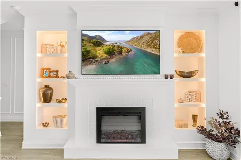 a living room with a fireplace and a painting on the wall