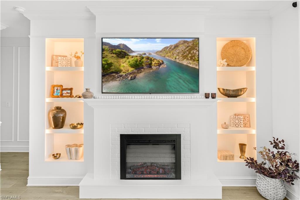 20507 Napa Loop Estero, FL 33928 - Photo 15 of 49 a living room with a fireplace and a painting on the wall