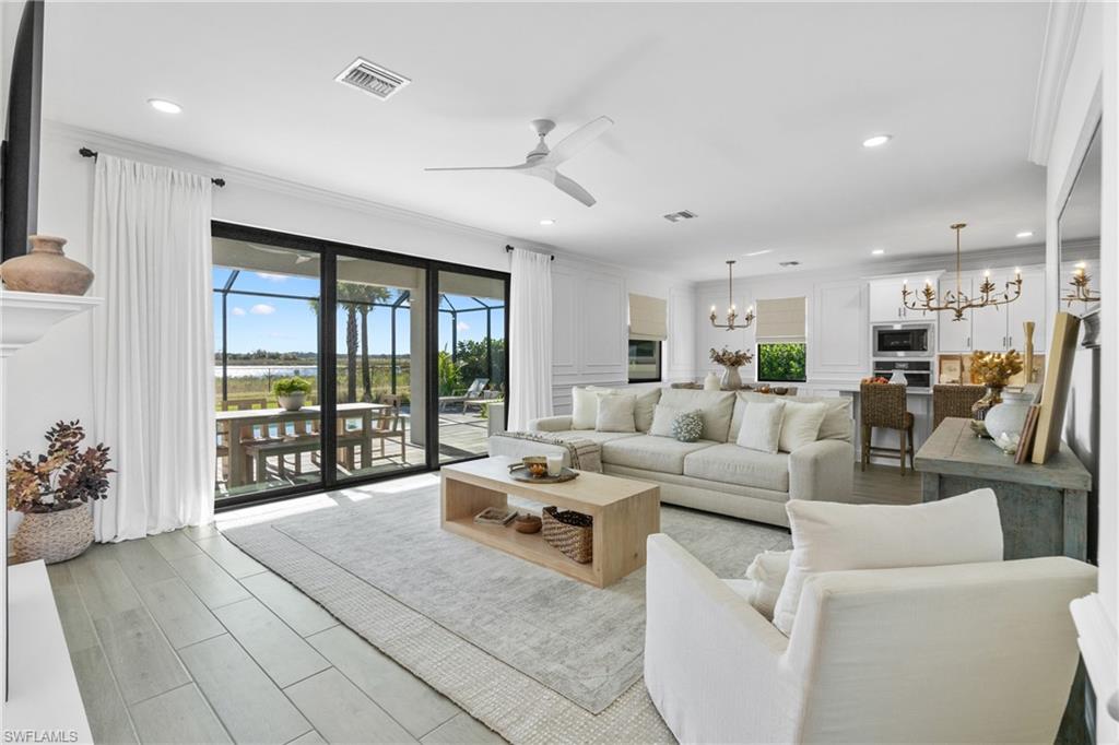 20507 Napa Loop Estero, FL 33928 - Photo 18 of 49 a living room with furniture and large windows