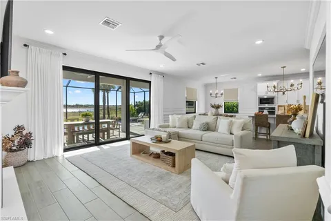 a living room with furniture and large windows