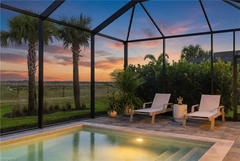 a swimming pool with outdoor seating yard and outdoor seating