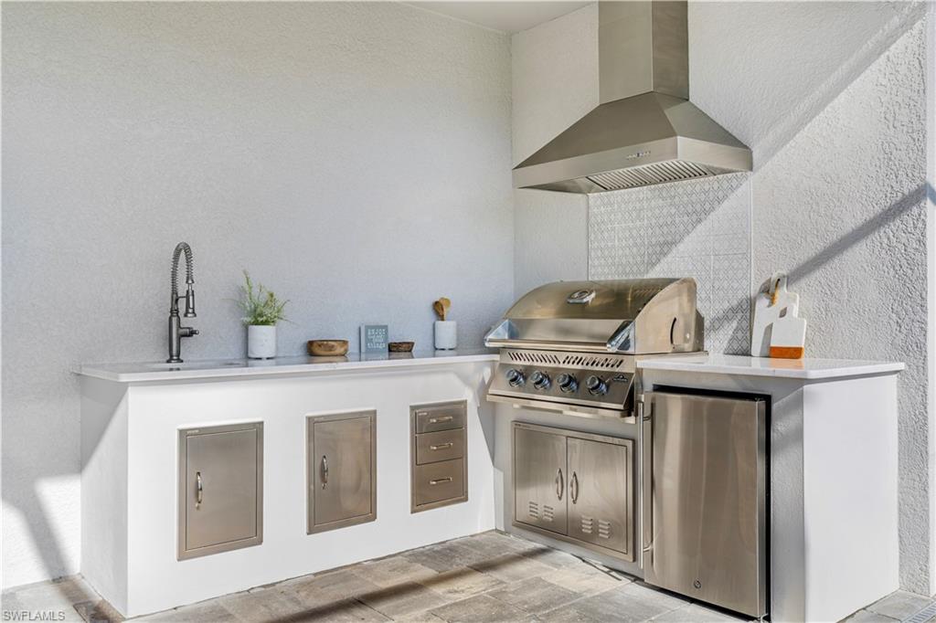 20507 Napa Loop Estero, FL 33928 - Photo 21 of 49 a kitchen with a stove and a sink