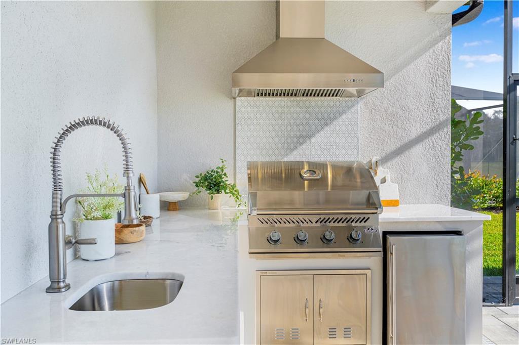 20507 Napa Loop Estero, FL 33928 - Photo 22 of 49 a kitchen with a stove and a sink