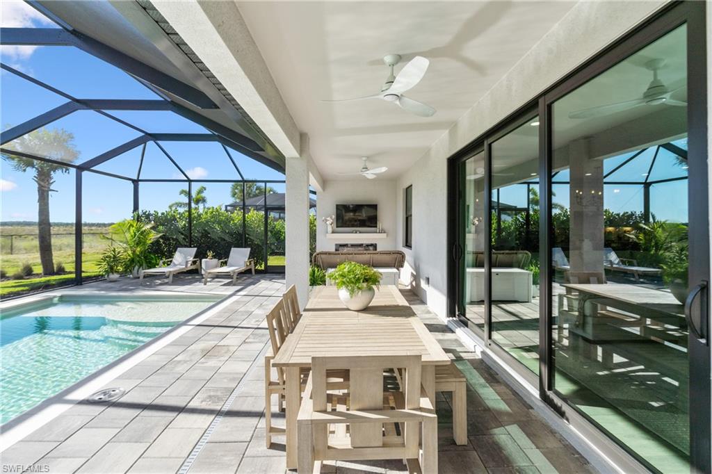 20507 Napa Loop Estero, FL 33928 - Photo 22 of 49 a view of a patio with a table and chairs under an umbrella