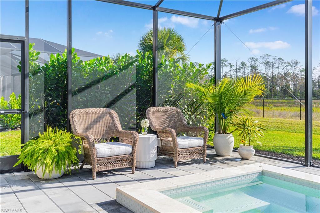 20507 Napa Loop Estero, FL 33928 - Photo 25 of 49 a view of a patio with plants and chairs under an umbrella