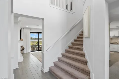a view of entryway and hall with wooden floor