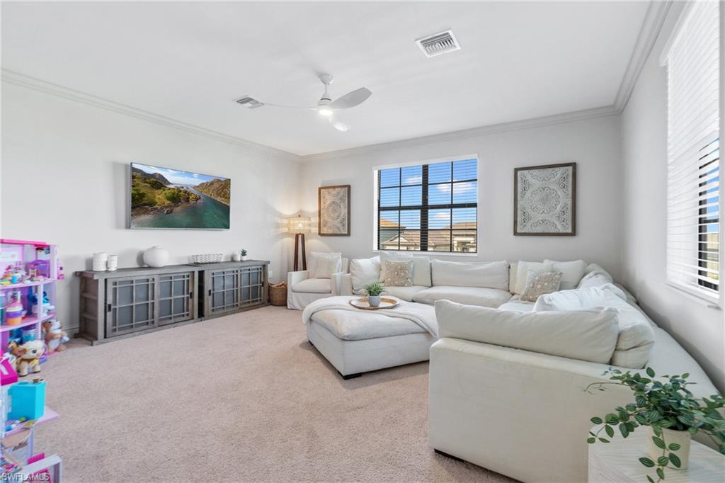 20507 Napa Loop Estero, FL 33928 - Photo 31 of 49 a living room with furniture and a flat screen tv