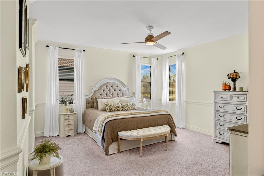 20507 Napa Loop Estero, FL 33928 - Photo 36 of 49 a bedroom with a bed a chandelier and a window