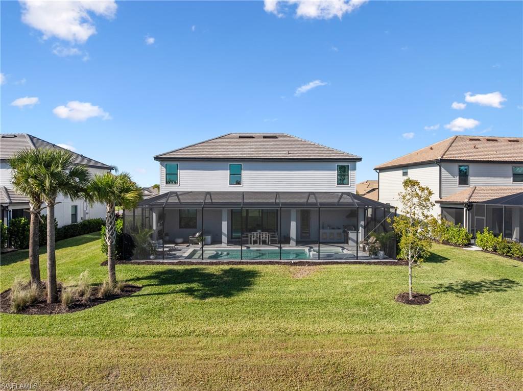 20507 Napa Loop Estero, FL 33928 - Photo 40 of 49 a view of a house with swimming pool and a yard