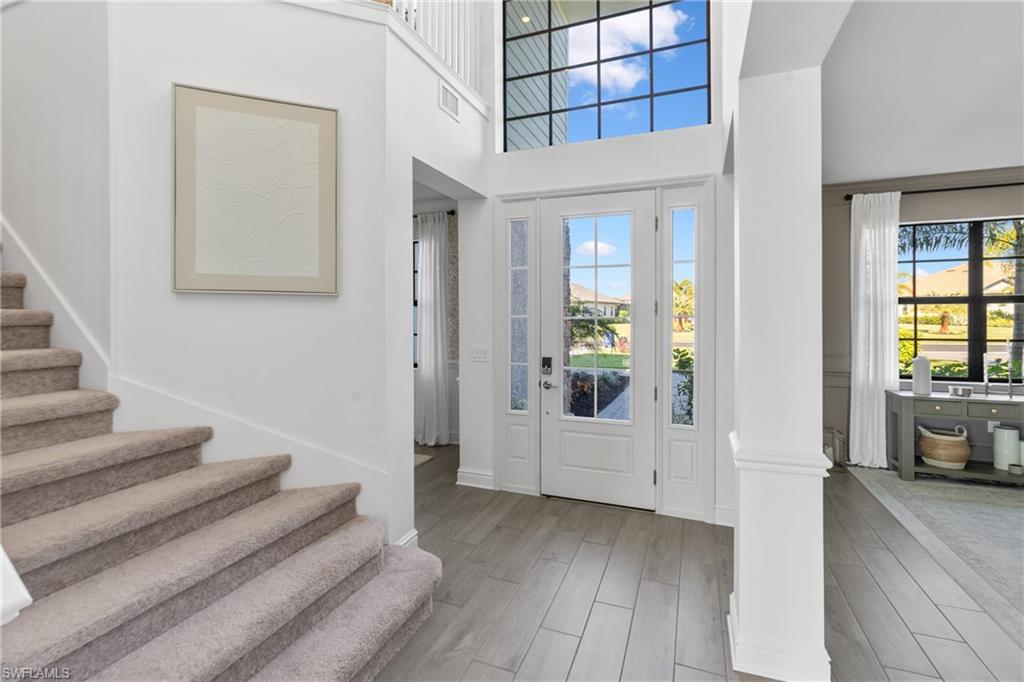 20507 Napa Loop Estero, FL 33928 - Photo 6 of 49 a view of a hallway with wooden floor and windows