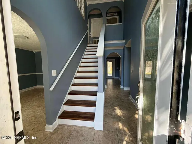 a view of entryway and hall with wooden floor