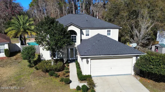 a aerial view of a house with a yard and plants