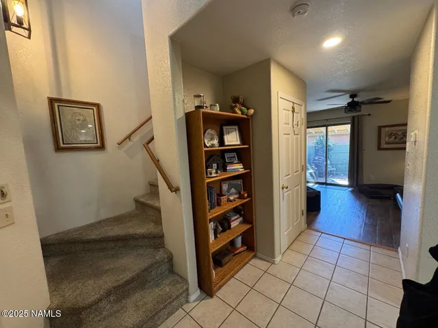 a view of a hallway with wooden shelves