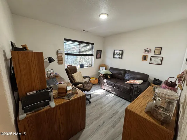 a living room with furniture window and a wooden floor