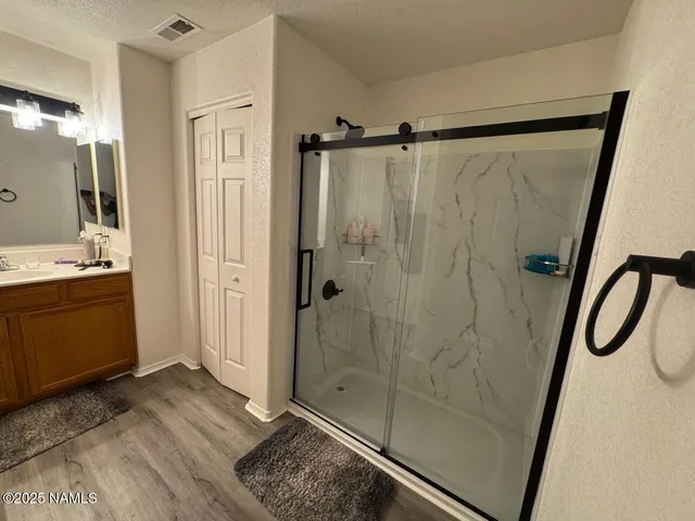 a bathroom with a shower and a sink