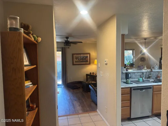 a view of a hallway and a livingroom with furniture