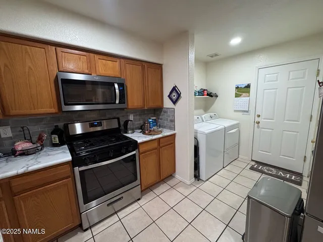 a kitchen with a stove a sink and a microwave