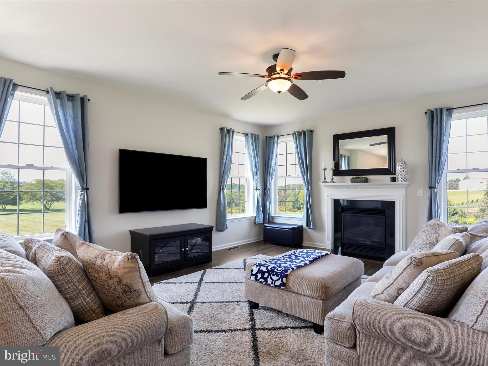 1147 Fox Run Terrace Hanover, PA 17331 - Photo 1 of 50 a living room with furniture a fireplace and a flat screen tv