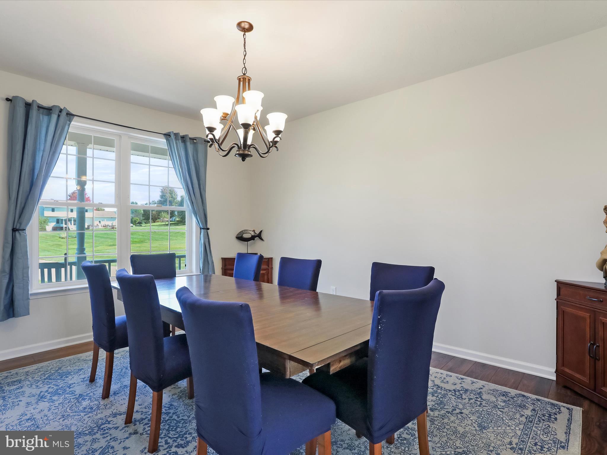 1147 Fox Run Terrace Hanover, PA 17331 - Photo 19 of 50 a view of a dining room with furniture a chandelier and wooden floor