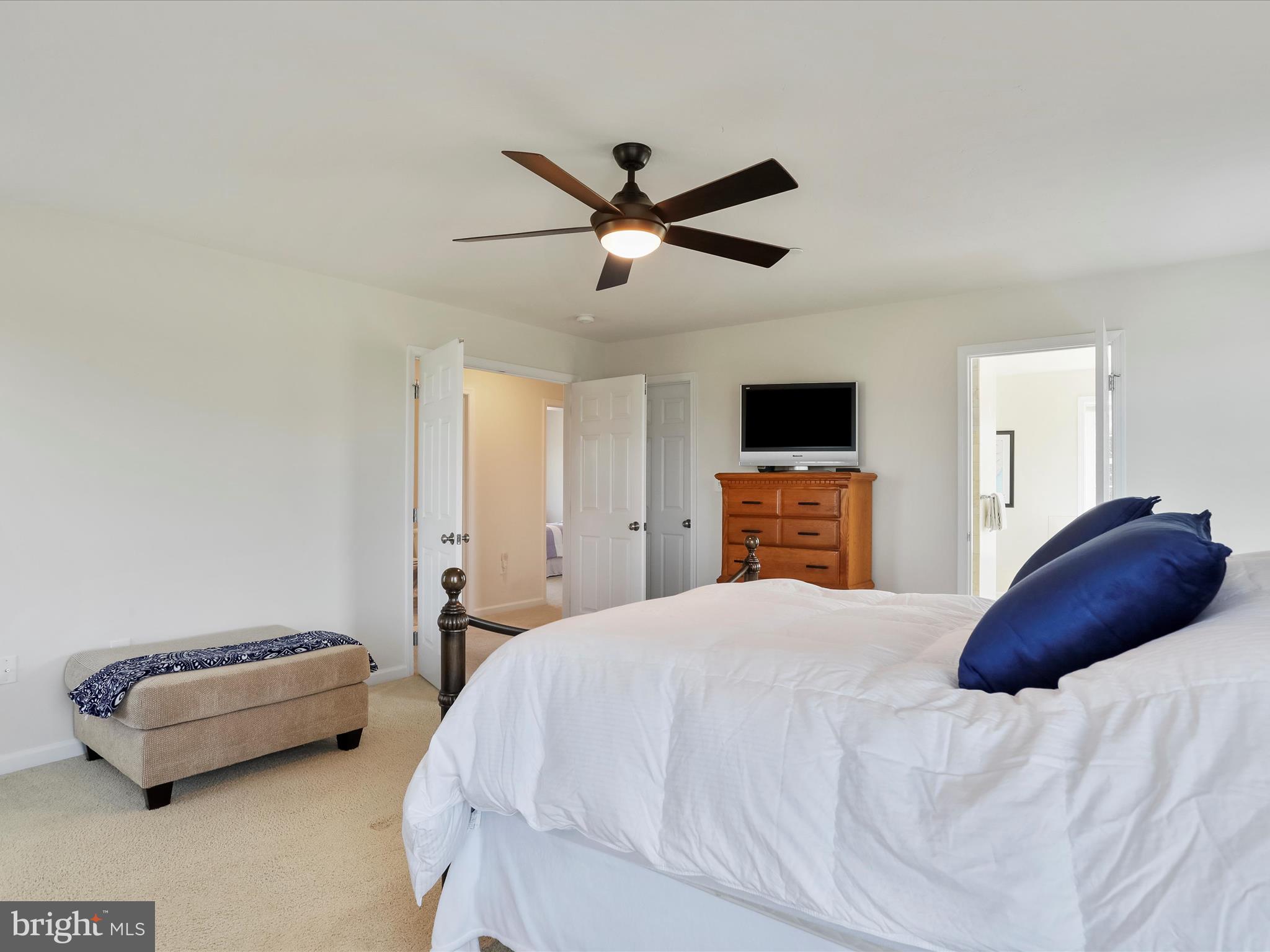 1147 Fox Run Terrace Hanover, PA 17331 - Photo 31 of 50 a bedroom with a bed a couch and a ceiling fan