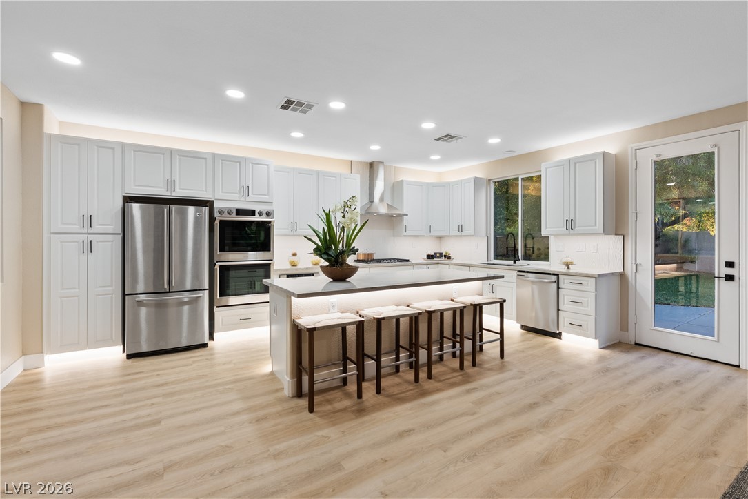 1662 Ravanusa Drive Henderson, NV 89052 - Photo 62 of 74 Culinary excellence awaits in this well-appointed kitchen, featuring a spacious island with seating and modern stainless-steel appliances.