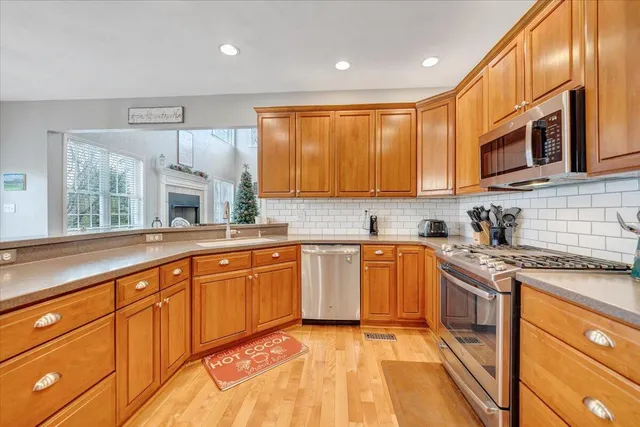 a front view of house with yard and trees in the background