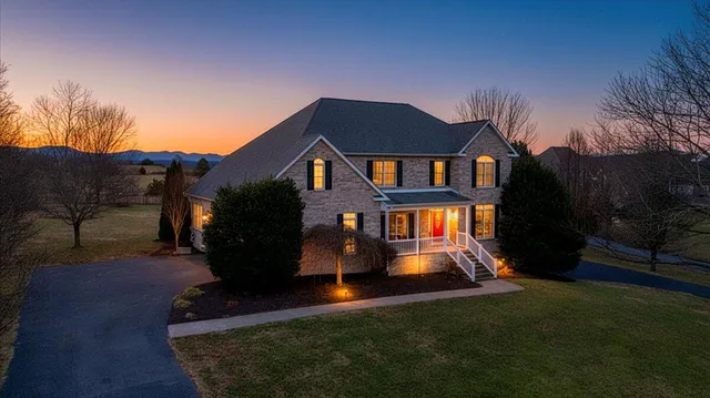 a kitchen with stainless steel appliances granite countertop a stove top oven a sink dishwasher a refrigerator and a microwave oven with wooden floor