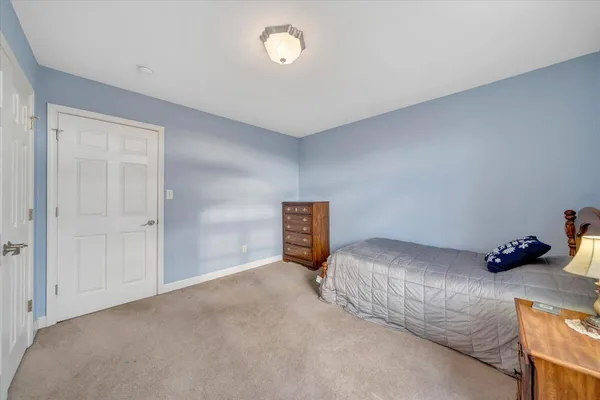 a living room with furniture a wooden floor and next to a window