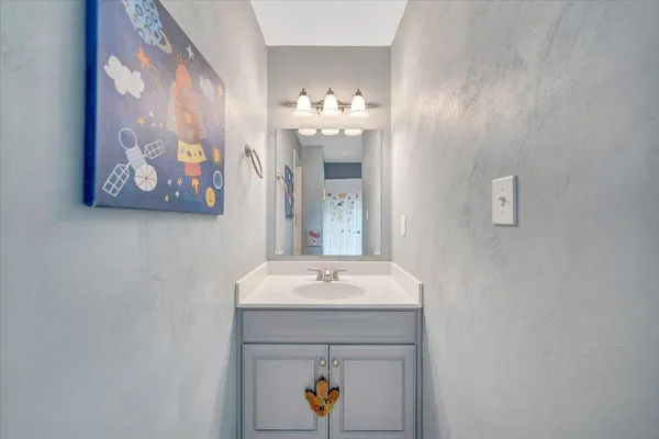 a front view of house with yard and trees in the background