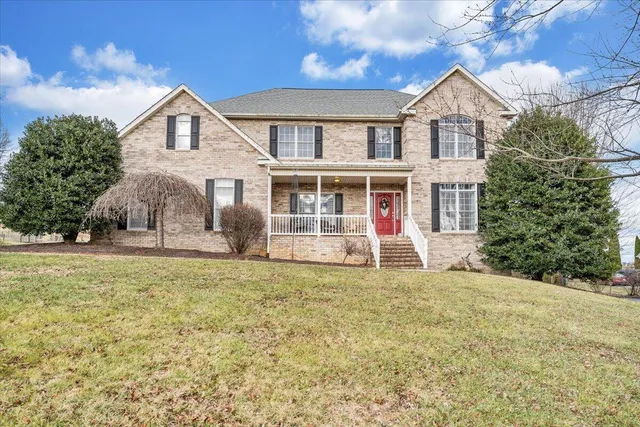 a kitchen with stainless steel appliances granite countertop a stove a sink and a refrigerator with wooden cabinets