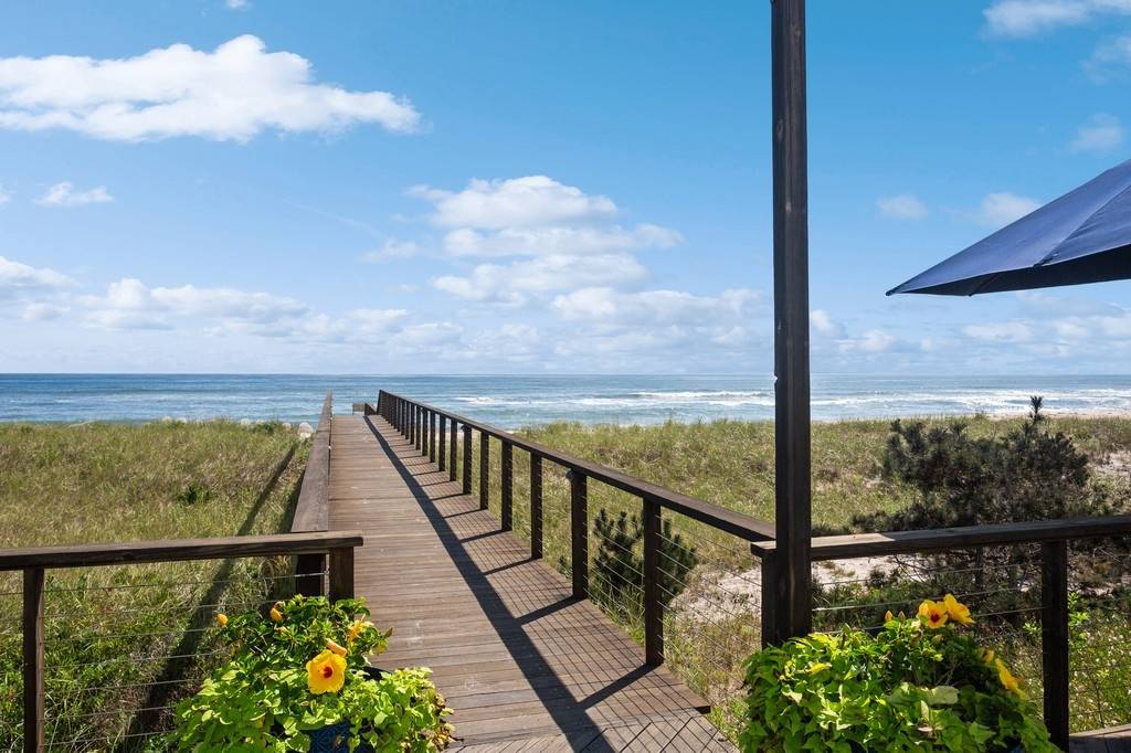 585 Dune Road Westhampton, NY 11978 - Photo 1 of 16 a view of a balcony next to a lake view