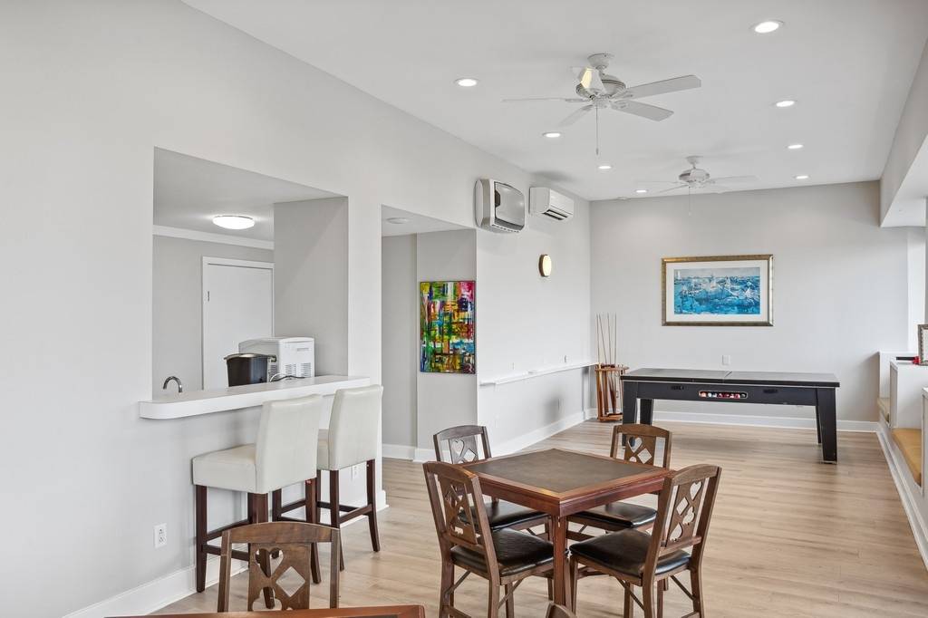 585 Dune Road Westhampton, NY 11978 - Photo 11 of 16 a view of a dining room with furniture and wooden floor