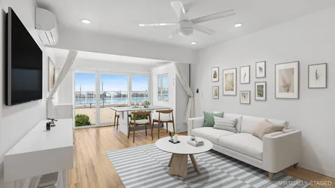 a living room with furniture and a view of kitchen