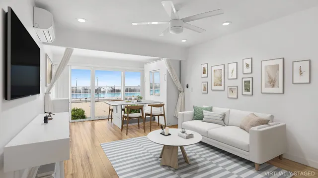 a living room with furniture and a view of kitchen