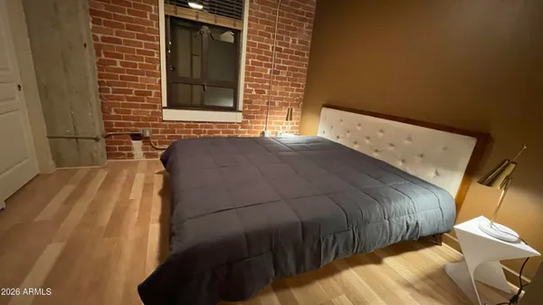 a bedroom with a bed and a window