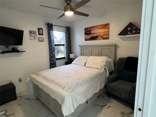 a bedroom with a bed and a flat screen tv