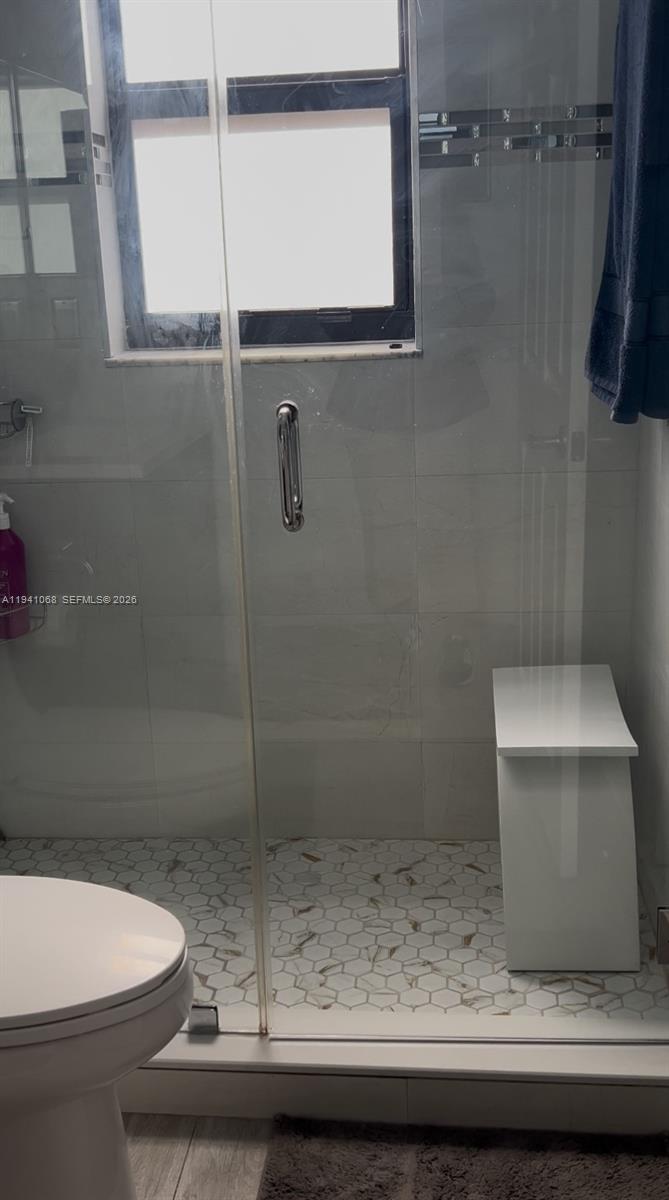 8618 Southwest 161st Place Miami, FL 33193 - Photo 17 of 33 a bathroom with a toilet and a sink