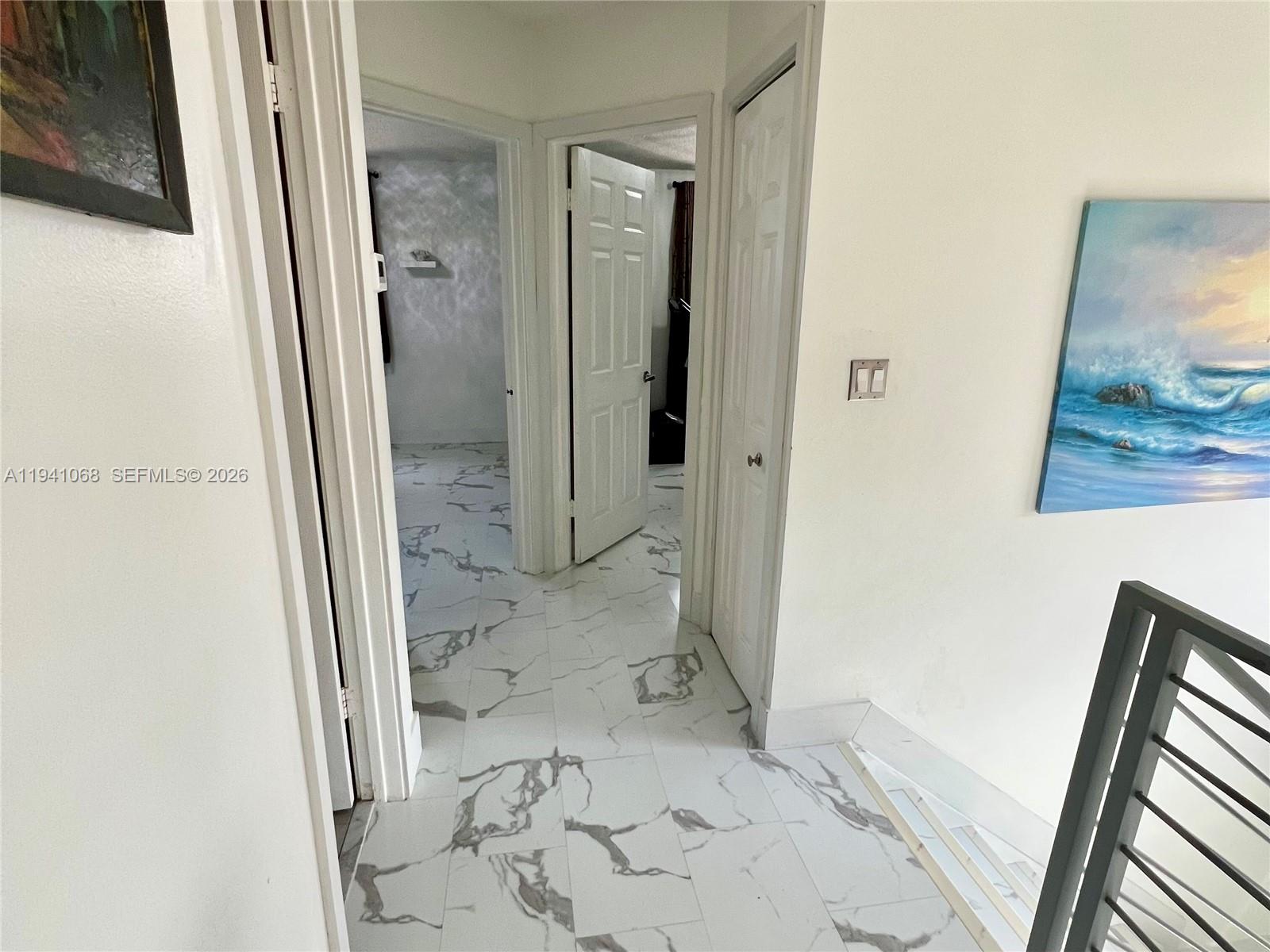 8618 Southwest 161st Place Miami, FL 33193 - Photo 18 of 33 a view of a bathroom from a corridor