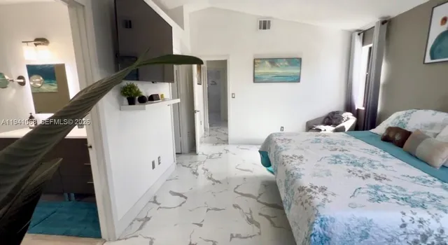 a bedroom with a bed and a couch