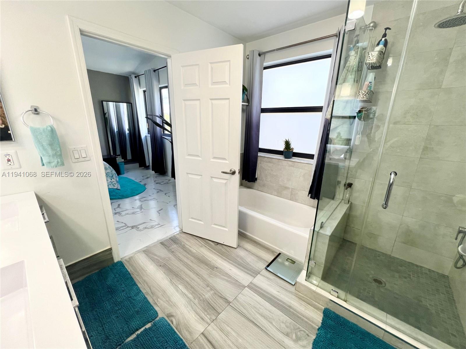 8618 Southwest 161st Place Miami, FL 33193 - Photo 28 of 33 a bathroom with a bathtub and a shower