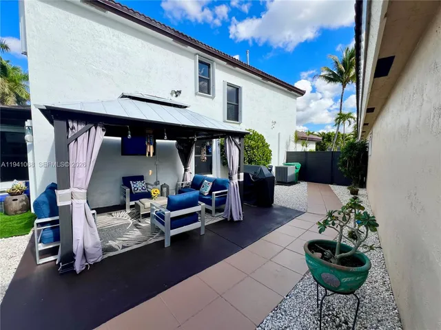 a view of a chairs and tables in patio of the house